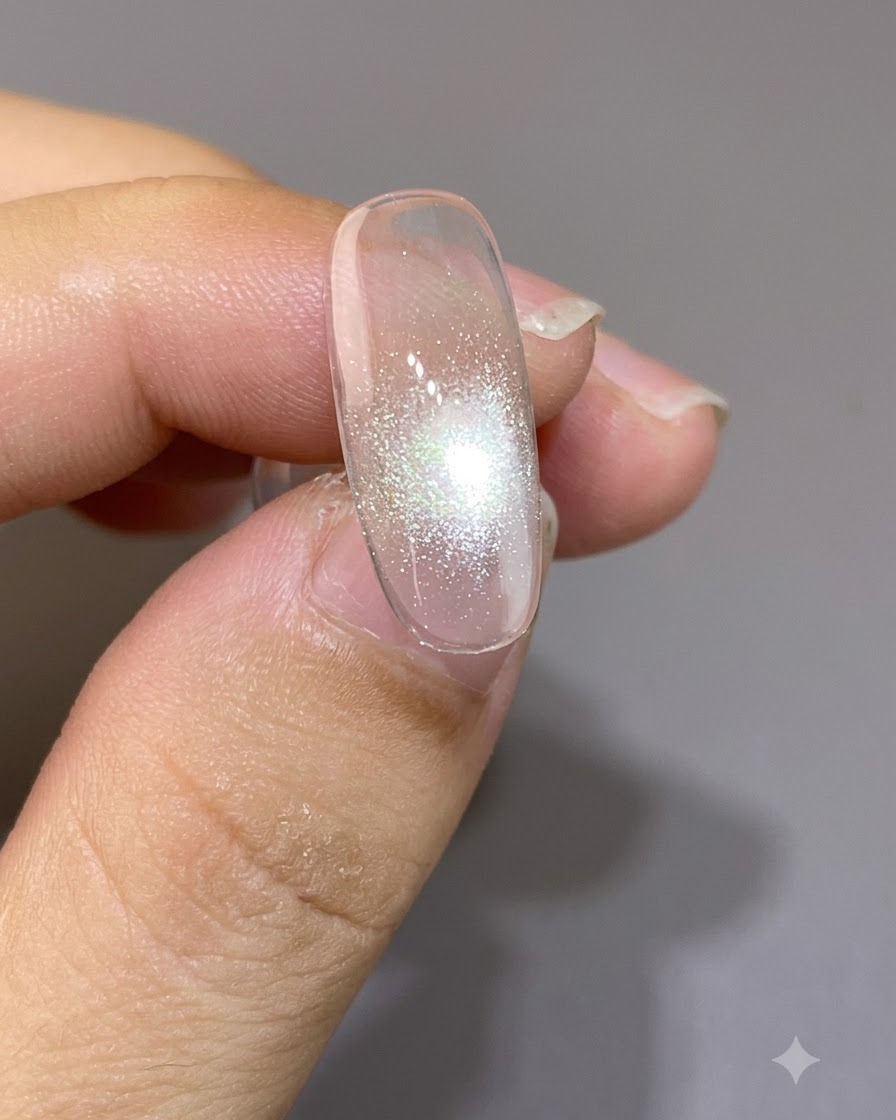 A magnet positioned closely over a nail, forming a tight and bright cat-eye focal point.