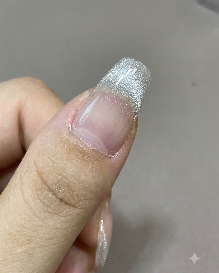 Magnets placed symmetrically on opposite sides of a nail to create a butterfly knot pattern in the cat-eye polish.
