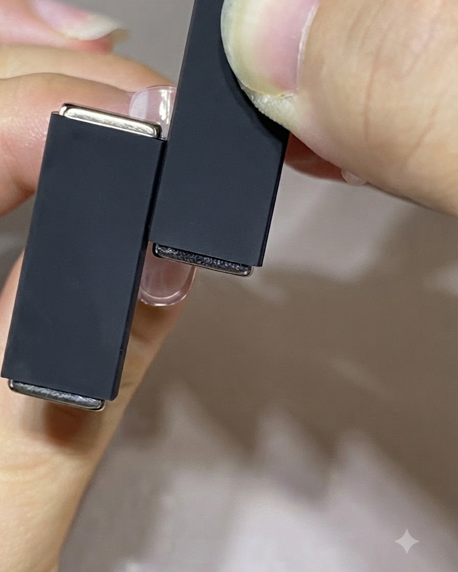 Two magnets of different sizes held in hands to demonstrate a multi-magnet technique.
