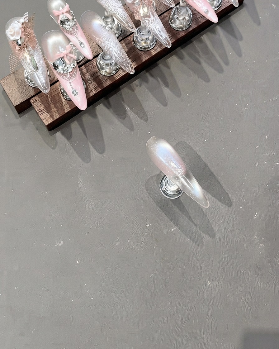 A clear jelly stamper picking up a detailed white pattern from an engraved metal plate.
