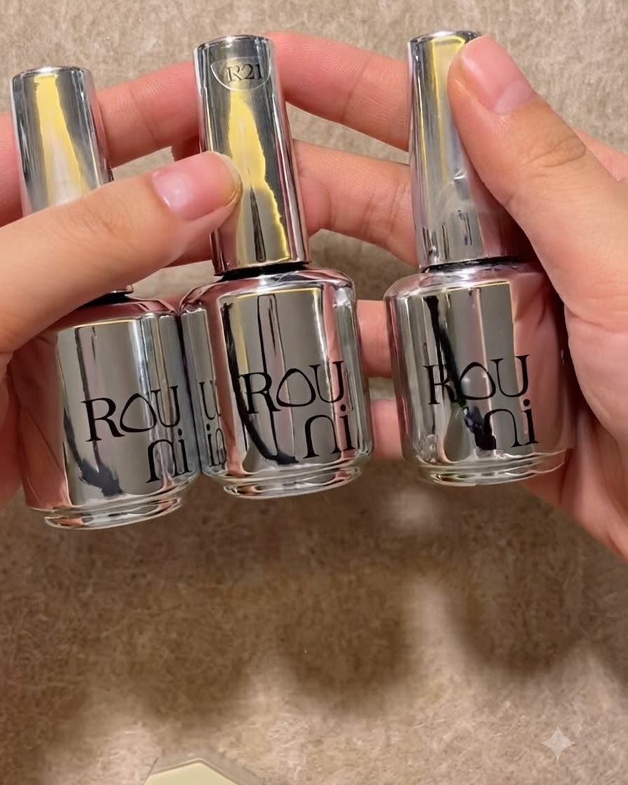 Three shiny silver gel bottles lined up neatly on a neutral surface.