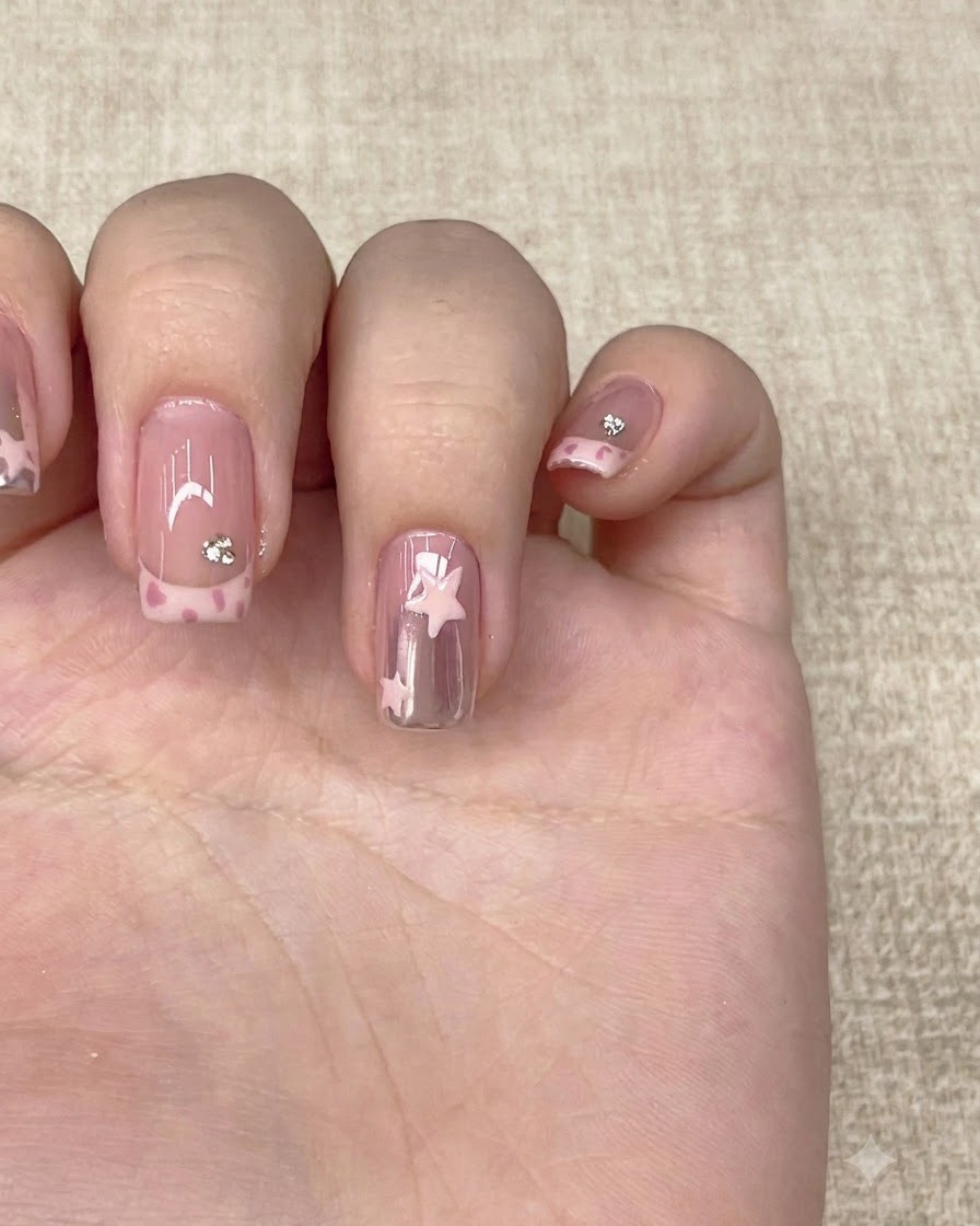 A clear top coat brush finishing a completed manicured hand with nail art.