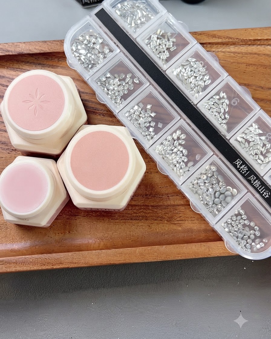 A nail brush applying a gentle nude pink gel base onto a prepped nail plate.