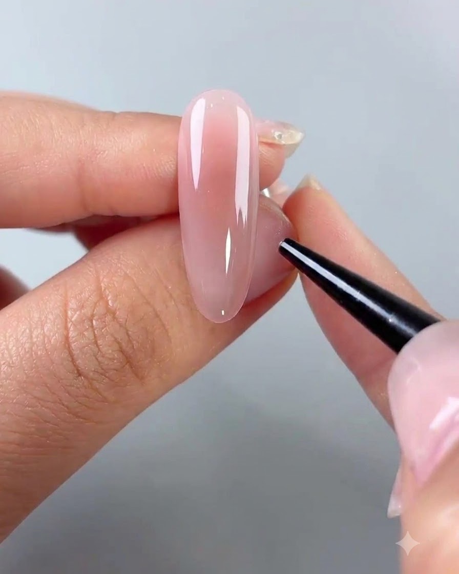 A fine-tipped tool placing small embellishments onto a gel-coated nail surface.
