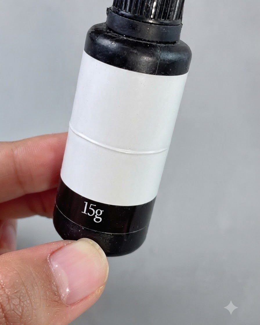 A fine detailing brush applying clear gap-filling gel around small square rhinestones on a manicured nail.