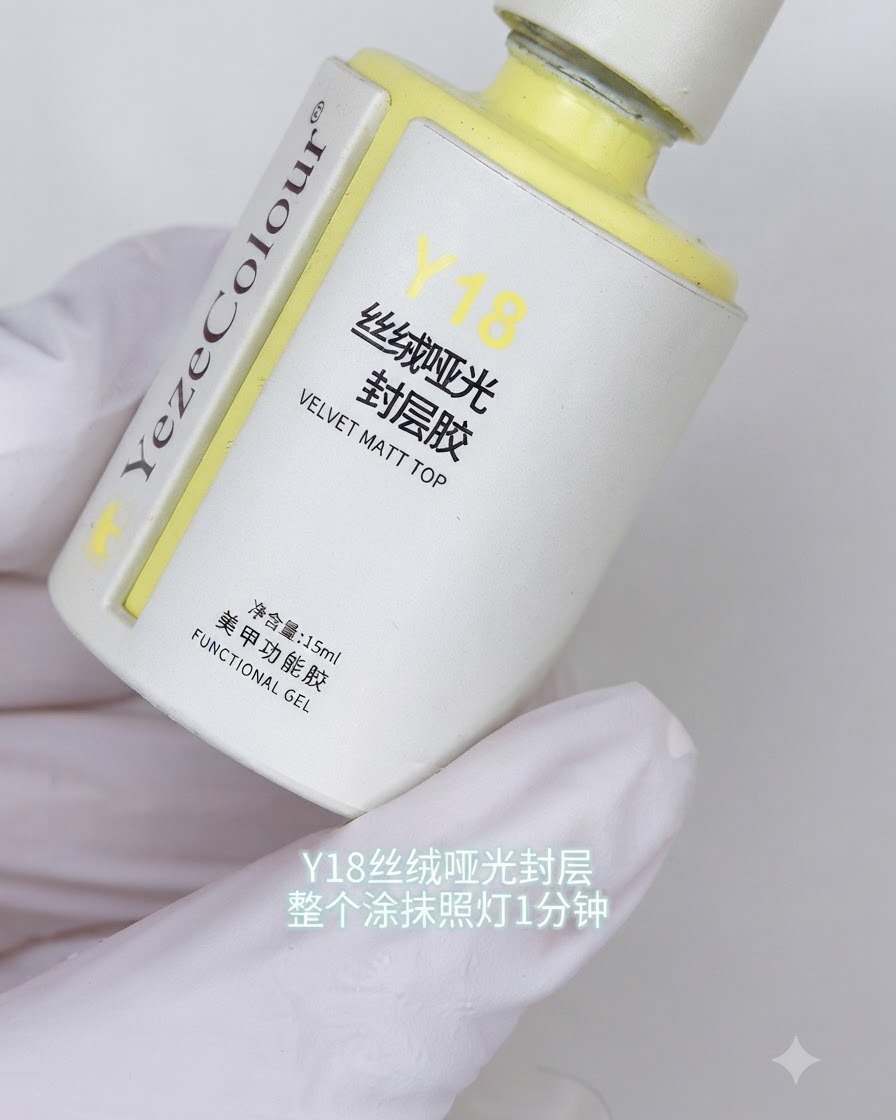 A bottle of Y18 velvet matte top coat held in a gloved hand with Korean text labels visible.