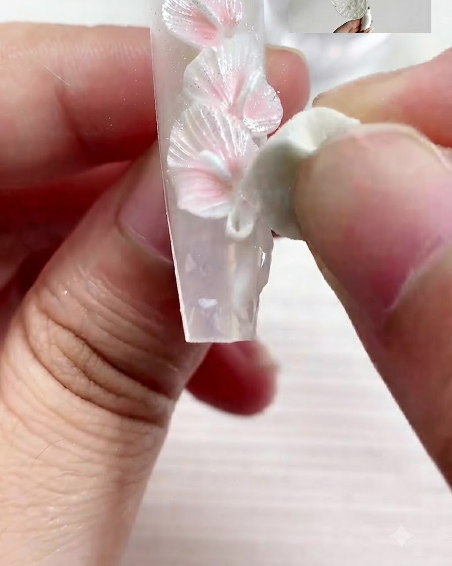 A fine brush applying detailed accents with S01 gel on the decorated nail.