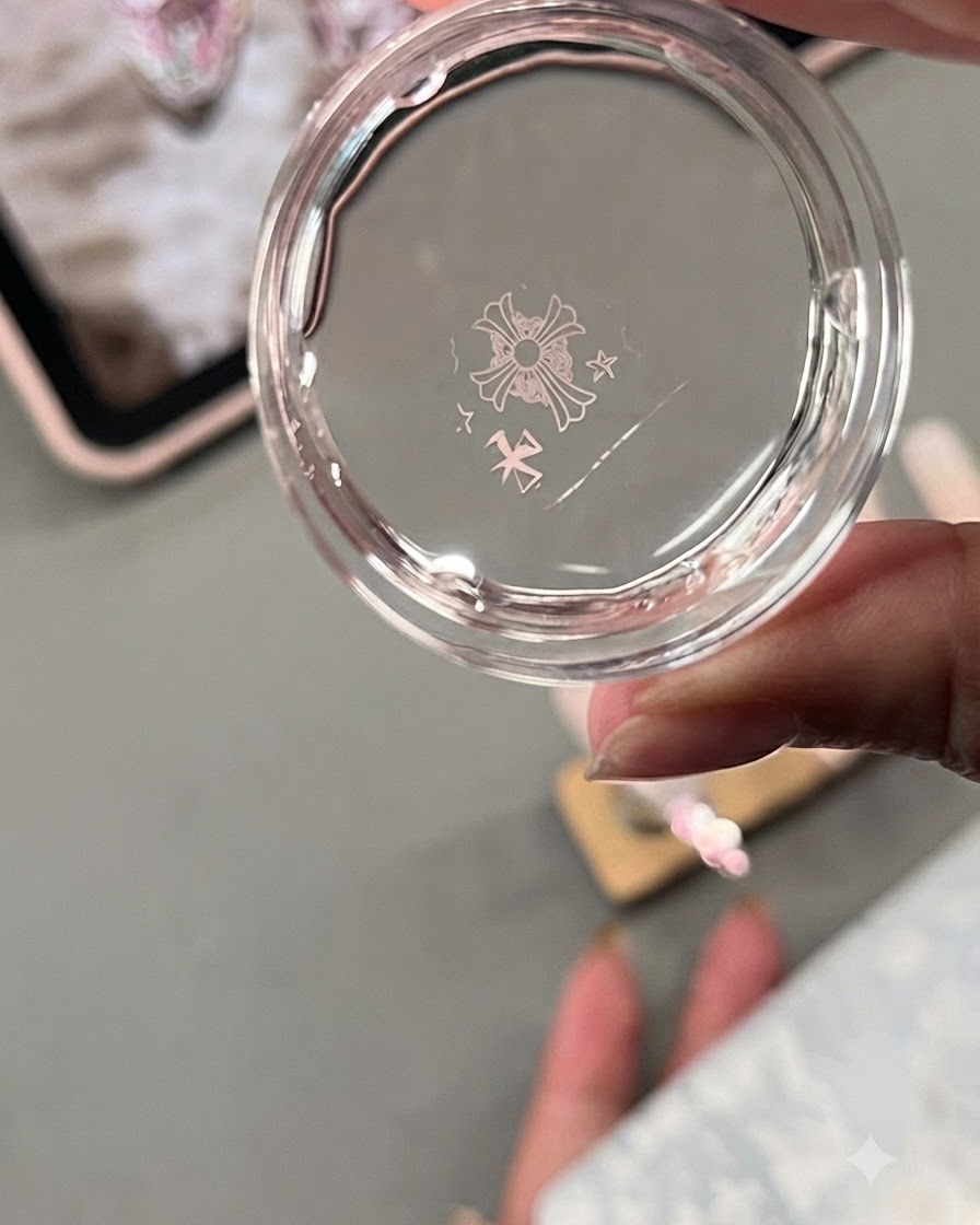 A clear jelly stamper head showing a transferred metal plate design of Chrome Hearts style crosses and stars.