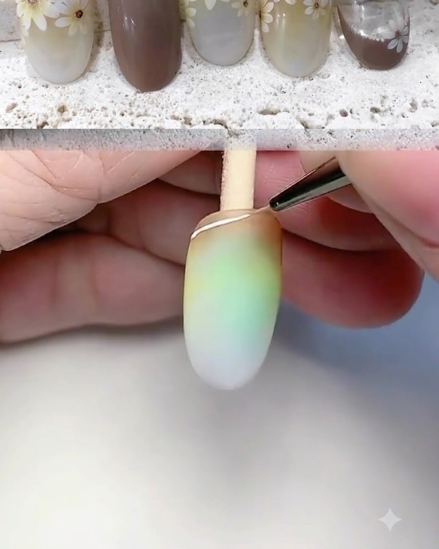A fine liner brush drawing a white outline and base line at the tip of the nail.