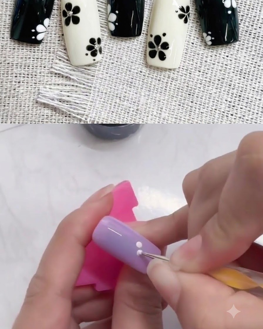 A dotting tool adding a second white dot adjacent to the first one on a purple nail.