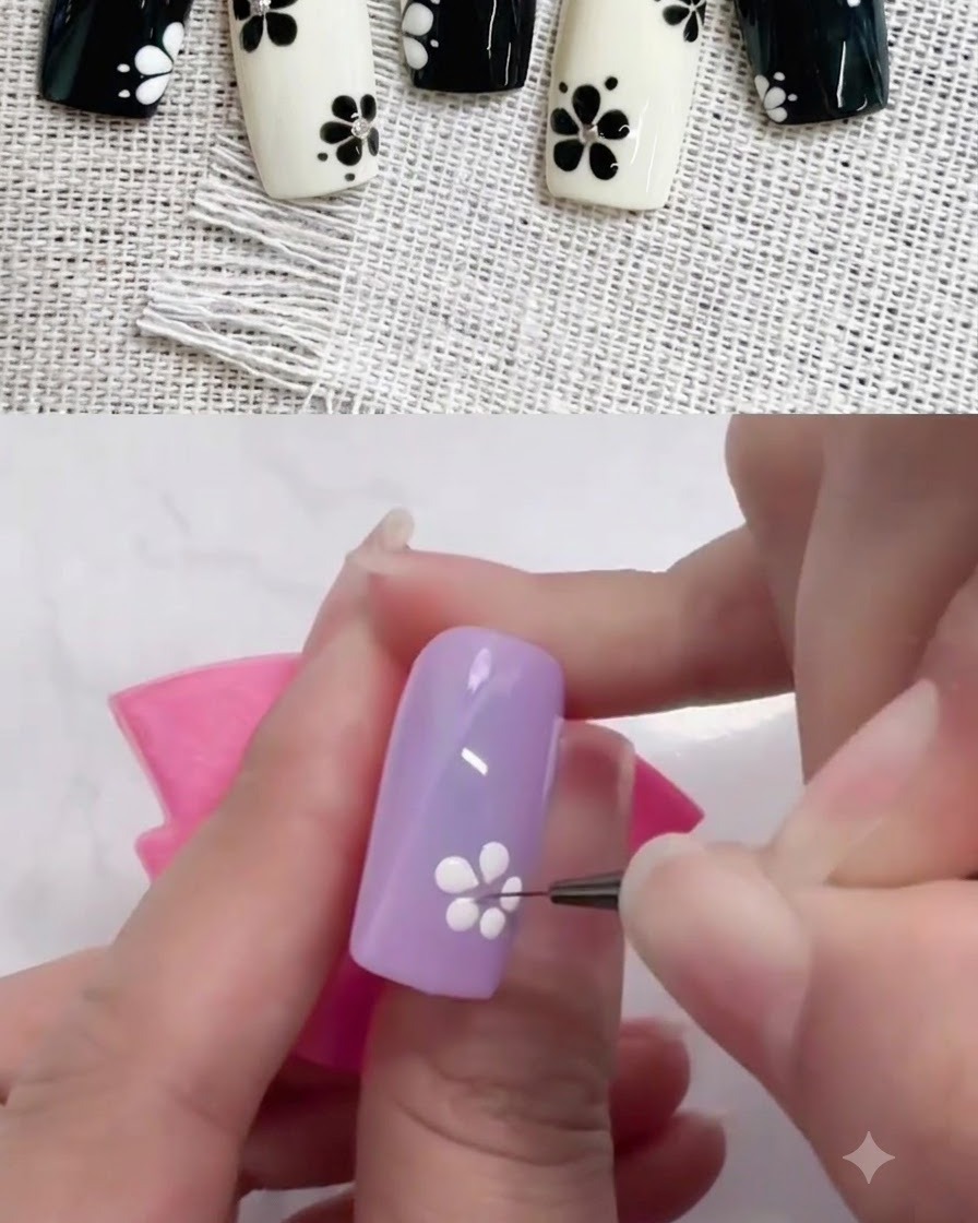 A fine liner brush dragging white gel dots inward to shape petals on a purple nail.