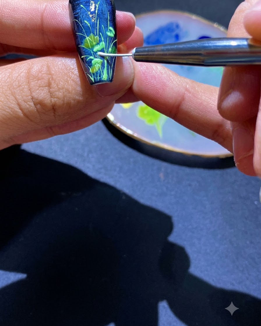 A fine detailing tool pressing out the outlines of daisy petals on a nail.