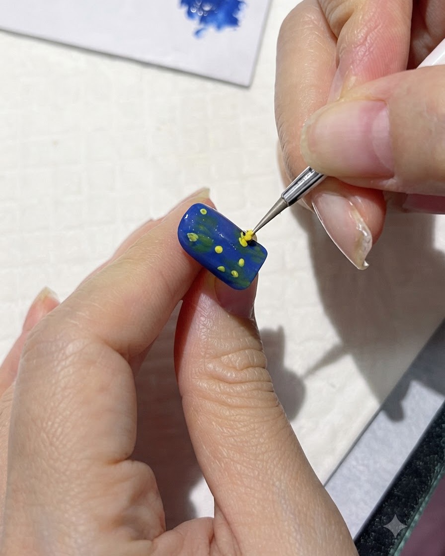 A fine brush painting loose yellow petal shapes around center dots on a blue nail.