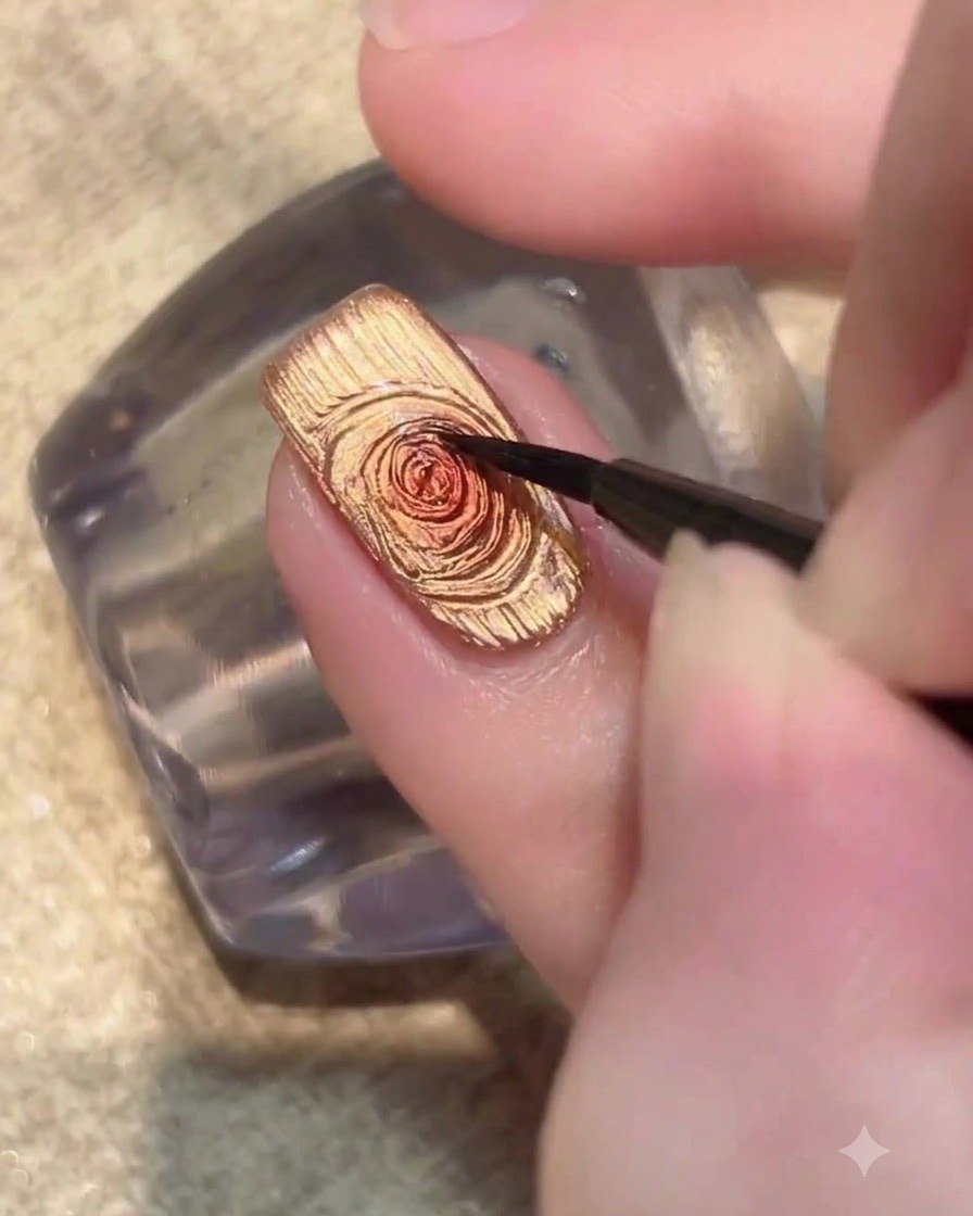 A nail illuminated under a UV LED lamp curing the gold cat-eye gel polish layer.