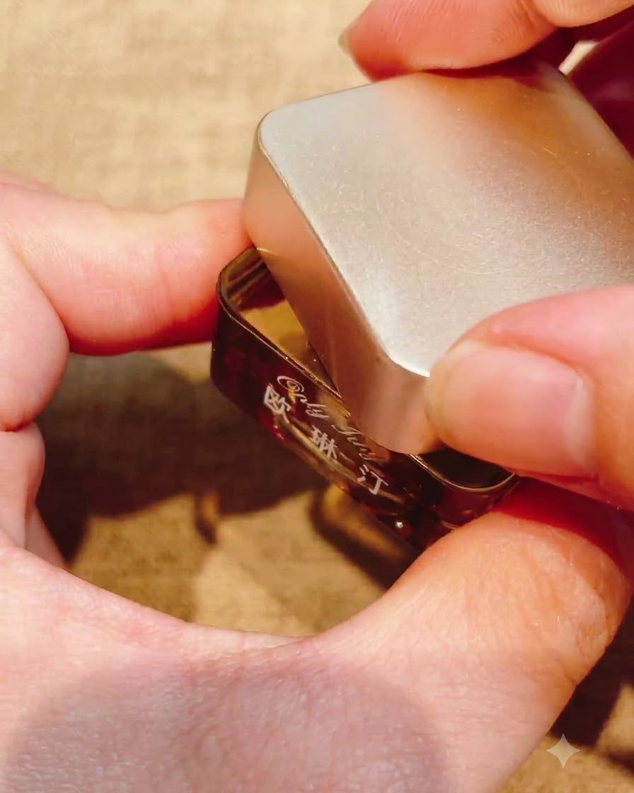 A brush applying a clear, glossy top coat over a textured nail design.