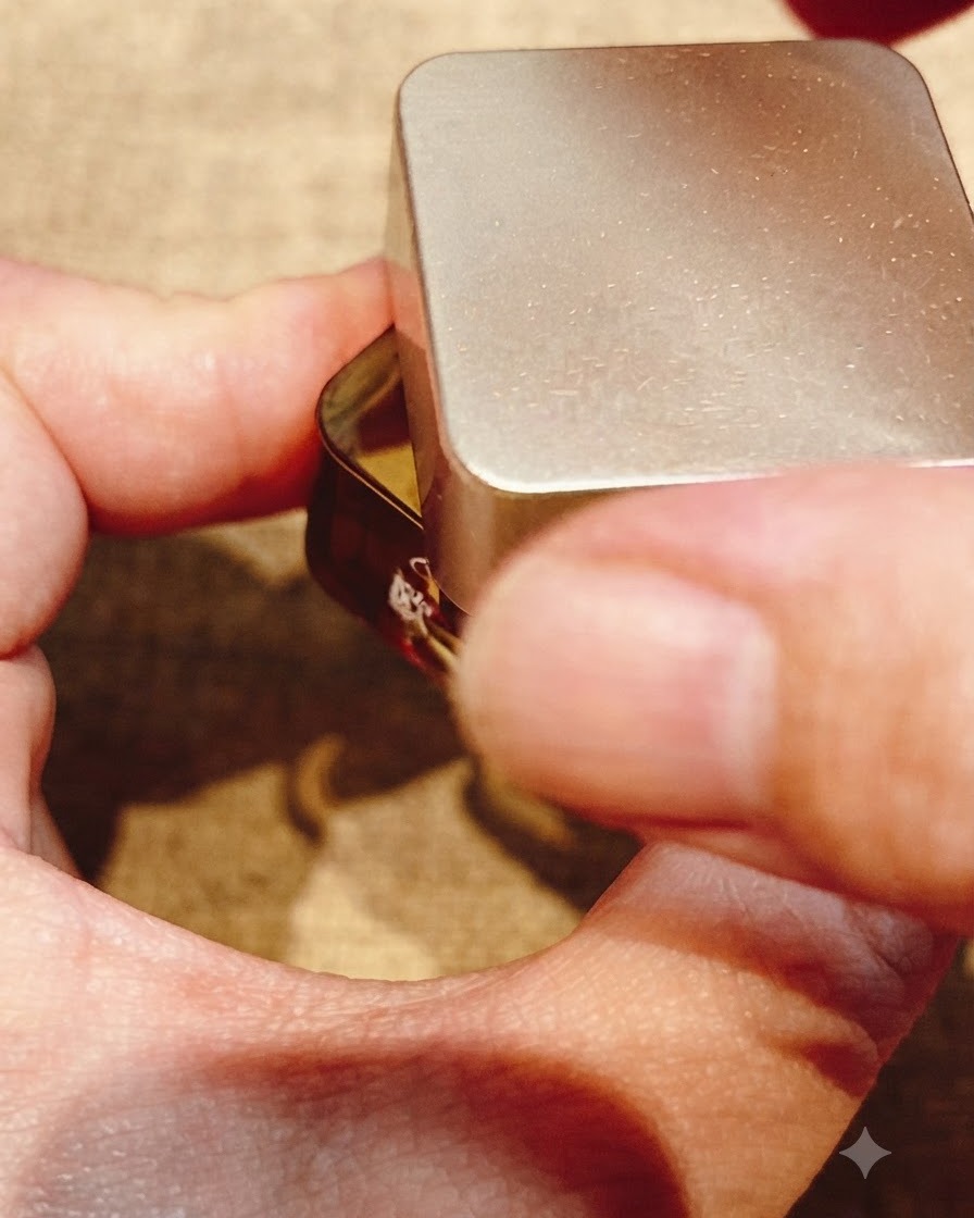 A small clean brush wiping away excess gel from the free edge of a fingernail.