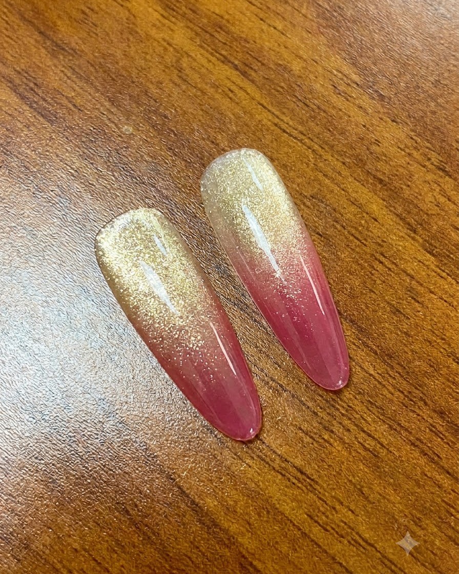 A magnet being drawn from the tip to the base of the nail to adjust the shimmer effect.