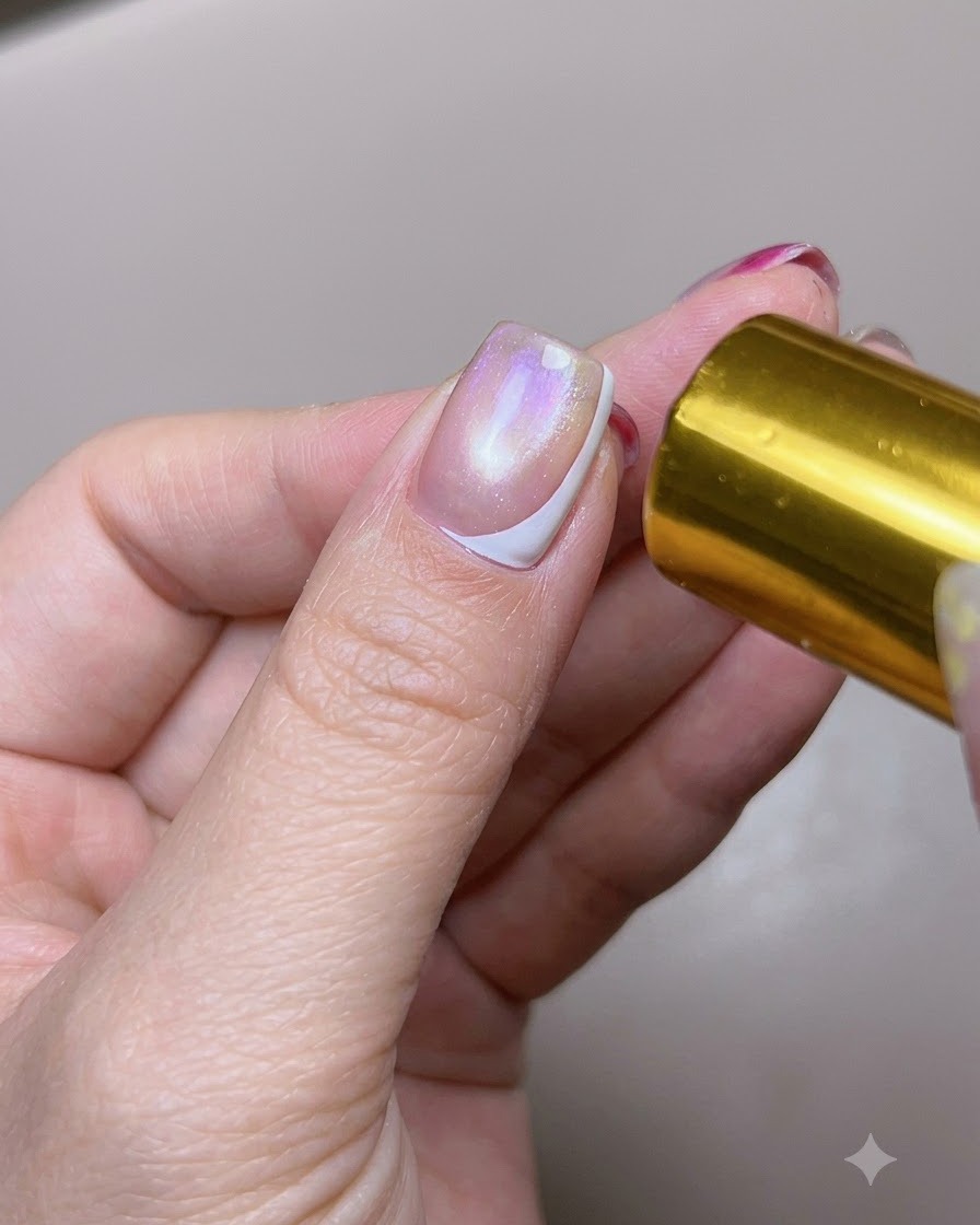 A thumbnail with a cured white side-French tip being exposed to a curing light.