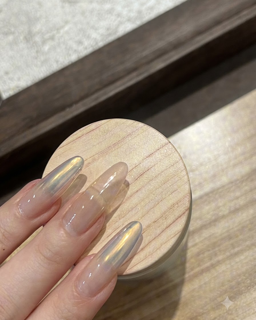 A clear reinforcing gel being brushed over the aurora powdered nail.