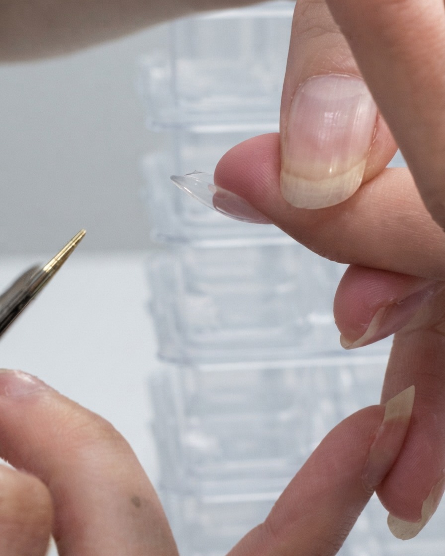 A finger being inverted briefly to level the building gel and create a natural apex structure.