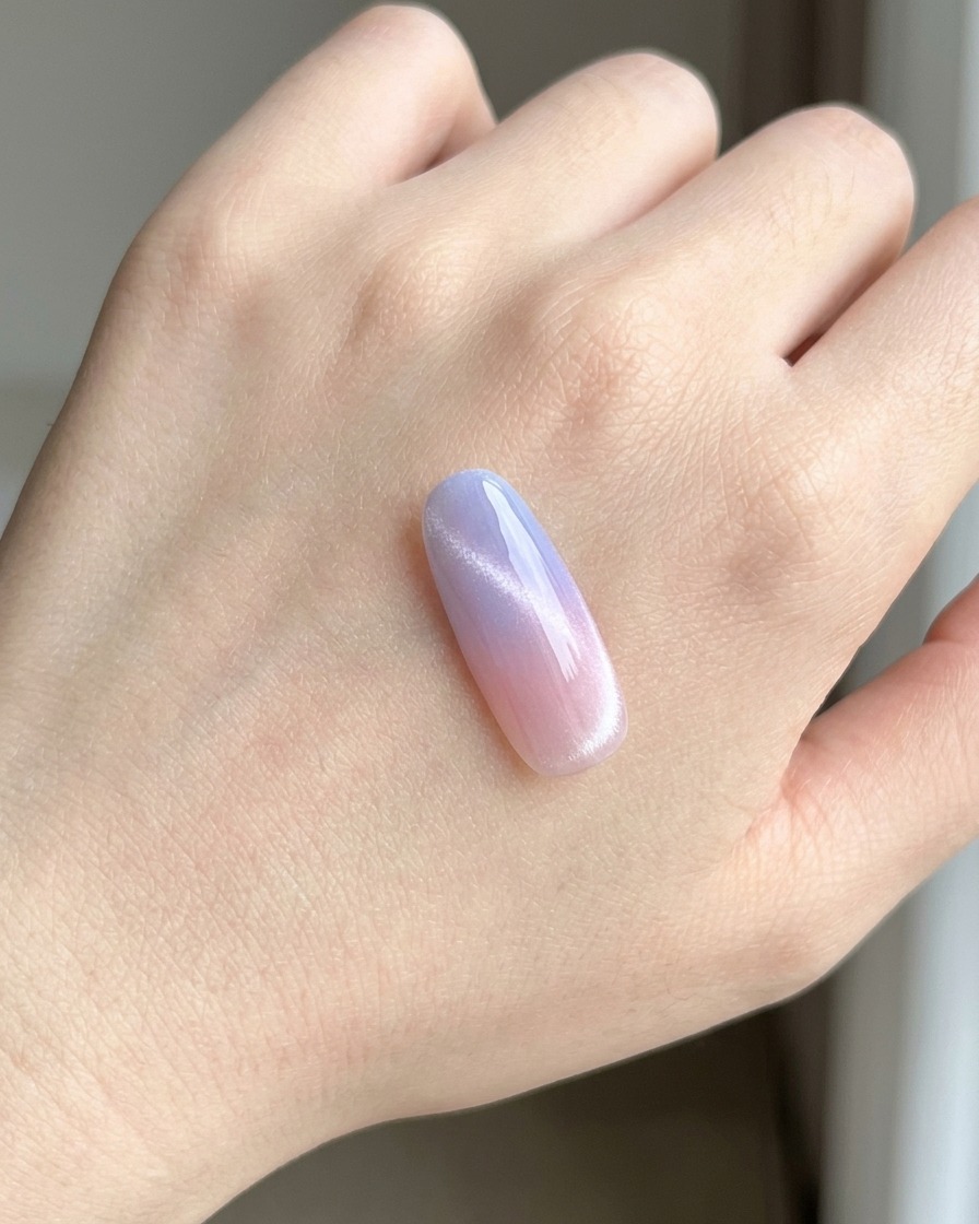 A nail tip placed under a UV/LED lamp while curing the base coat.