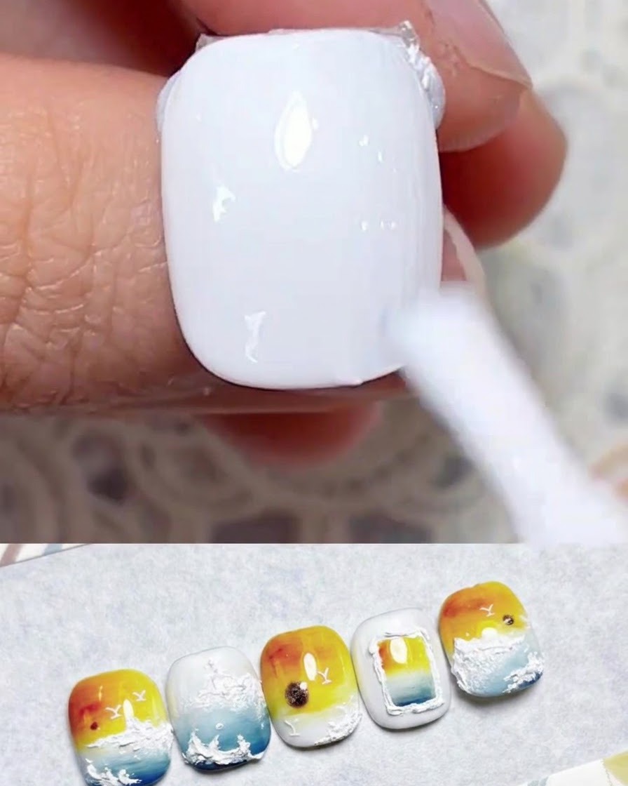 A nail brush applying a smooth coat of milky white gel polish onto a natural fingernail.