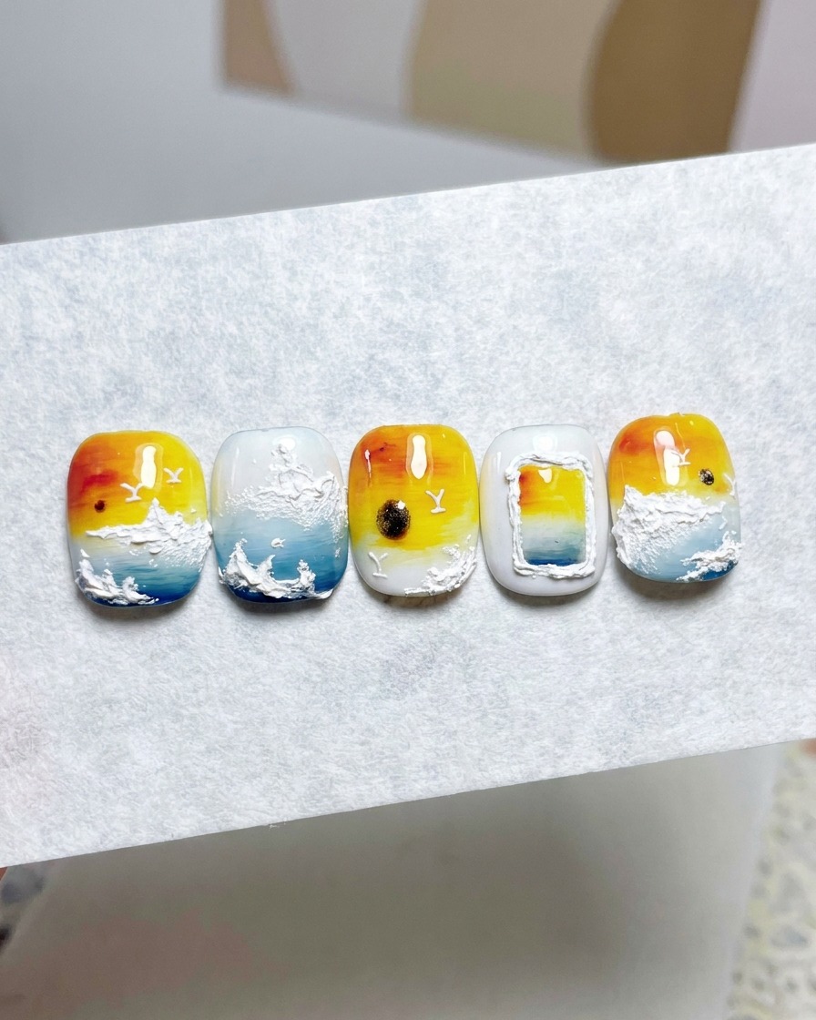 A close-up view of applying a second layer of milky white gel polish to create an opaque background.