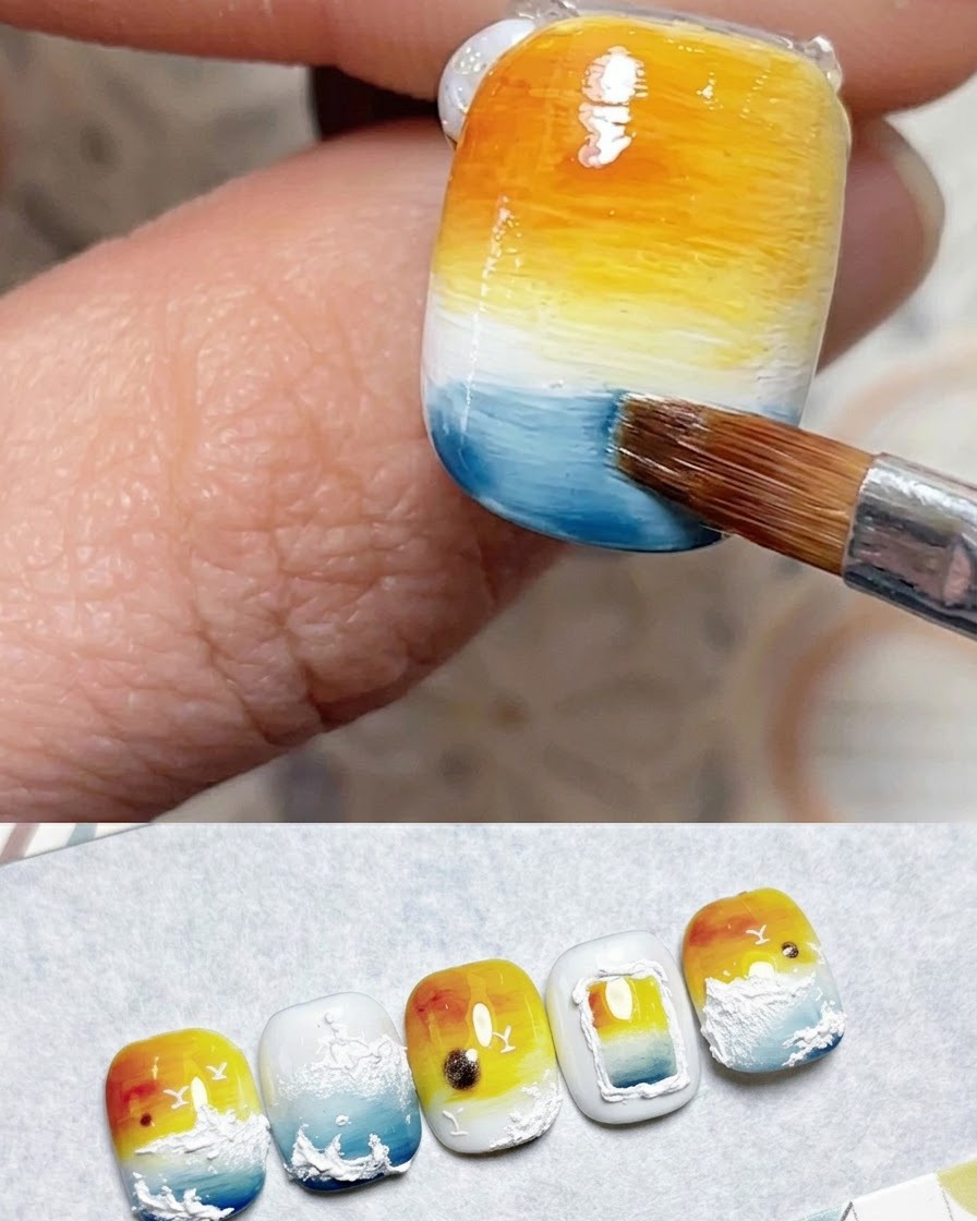 A brush applying dark blue gel along the bottom edge of the nail.