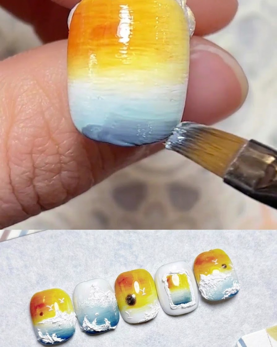 A brush blending blue gel layers on the lower section of the nail.