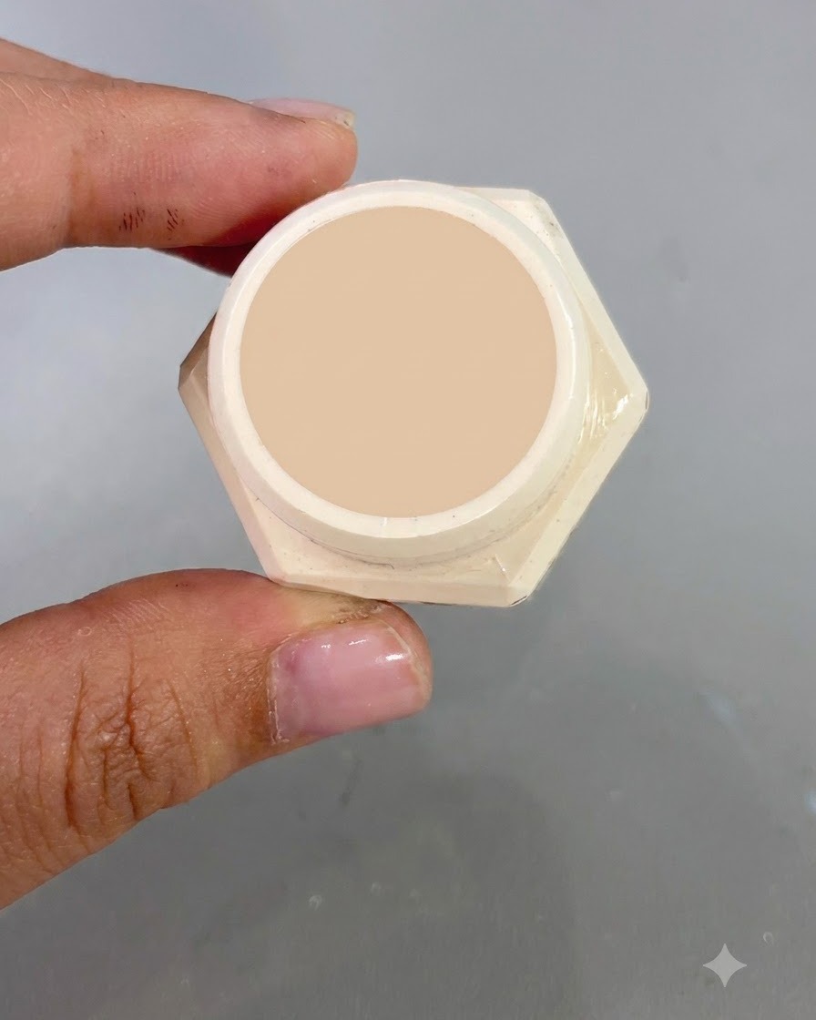 An open jar of flowing light gold gel No. 2 shown close-up in front of a nail background.