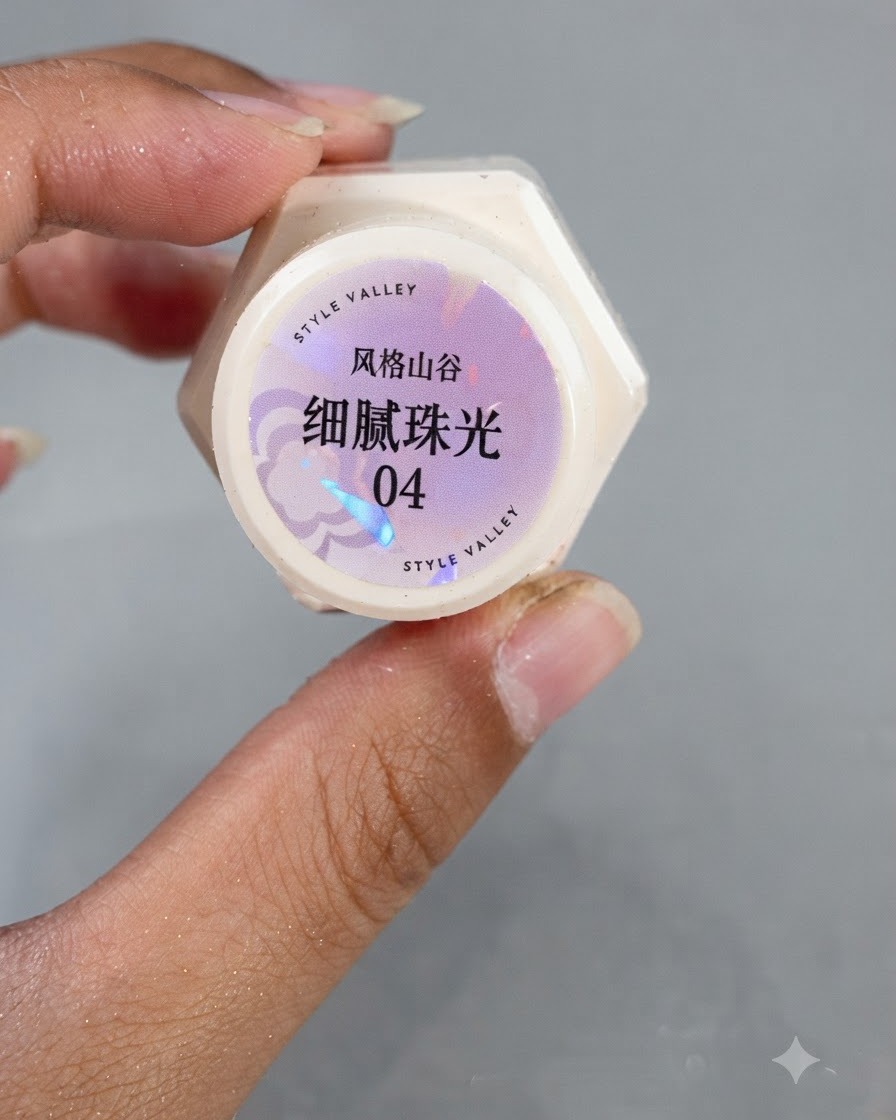 A brush applying pearlescent gel number 4 onto a nail surface.