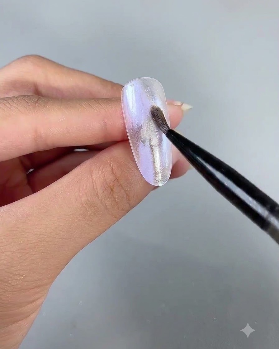 A fine art liner brush applying delicate pearlescent gel number 3 over the nail surface.
