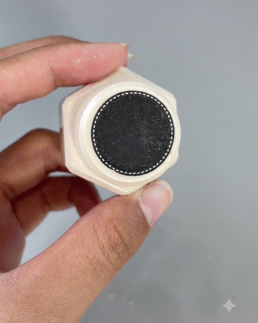 The bottom cap of a gel polish bottle showing a detailed textured pattern.