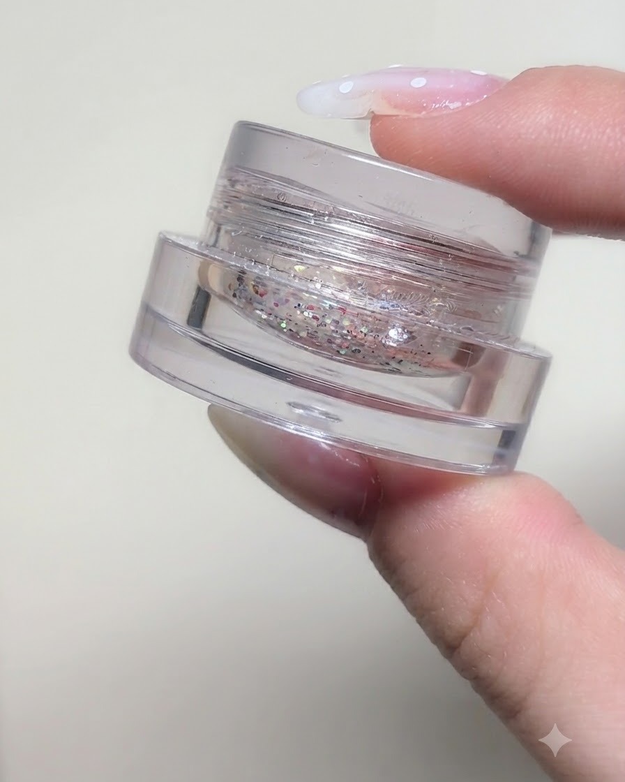 A small jar containing iridescent star glitter sequins and fine particles from the Fairy Tale series.