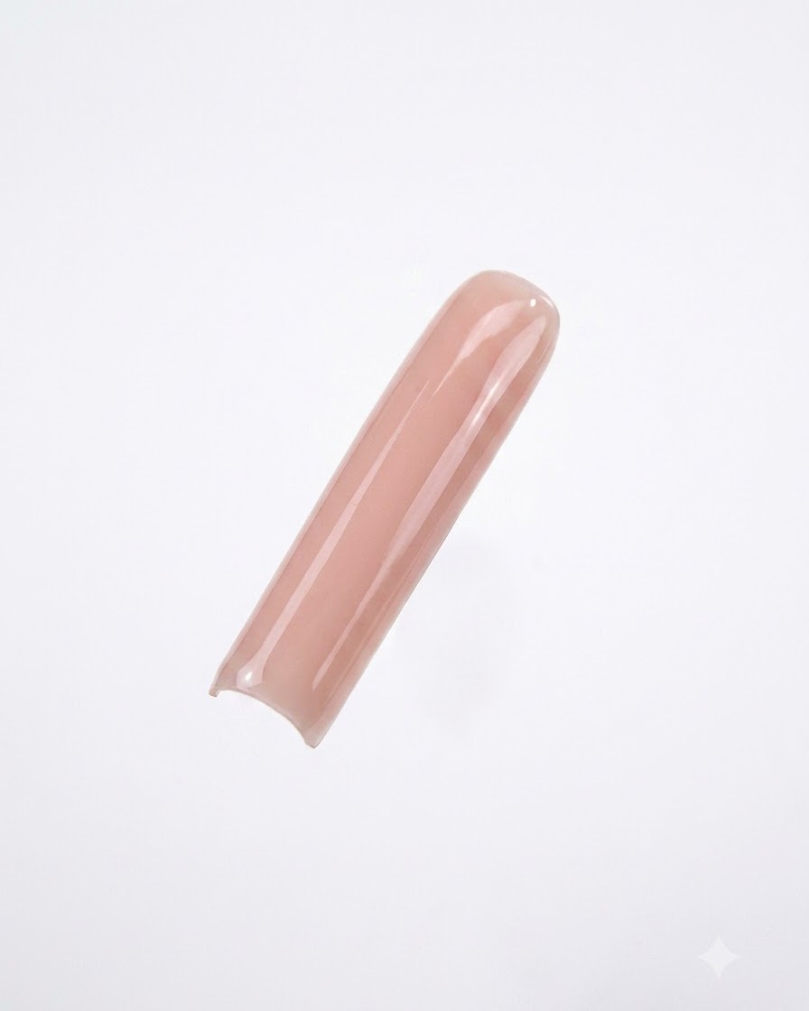 A long square nail tip painted with a smooth, opaque nude gel polish against a clean white background.