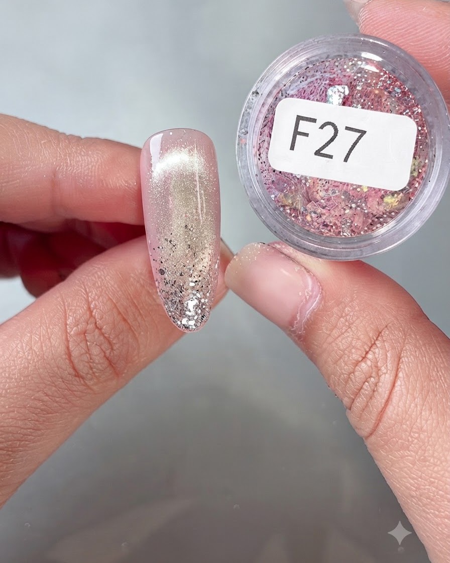 A close-up of a nail being decorated with colorful flake sequins from jar F27 using a fine tool.