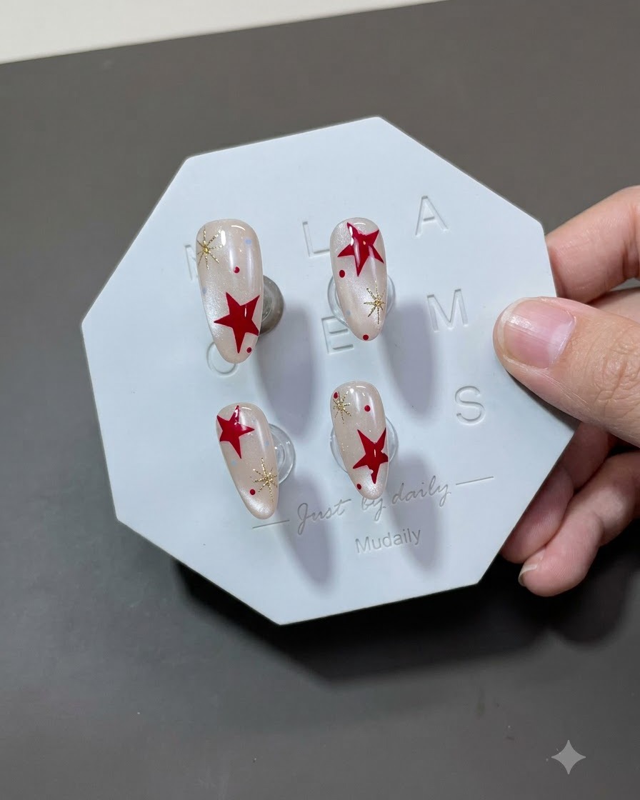 A top coat brush applying a shiny final layer over the completed star-decorated nail.