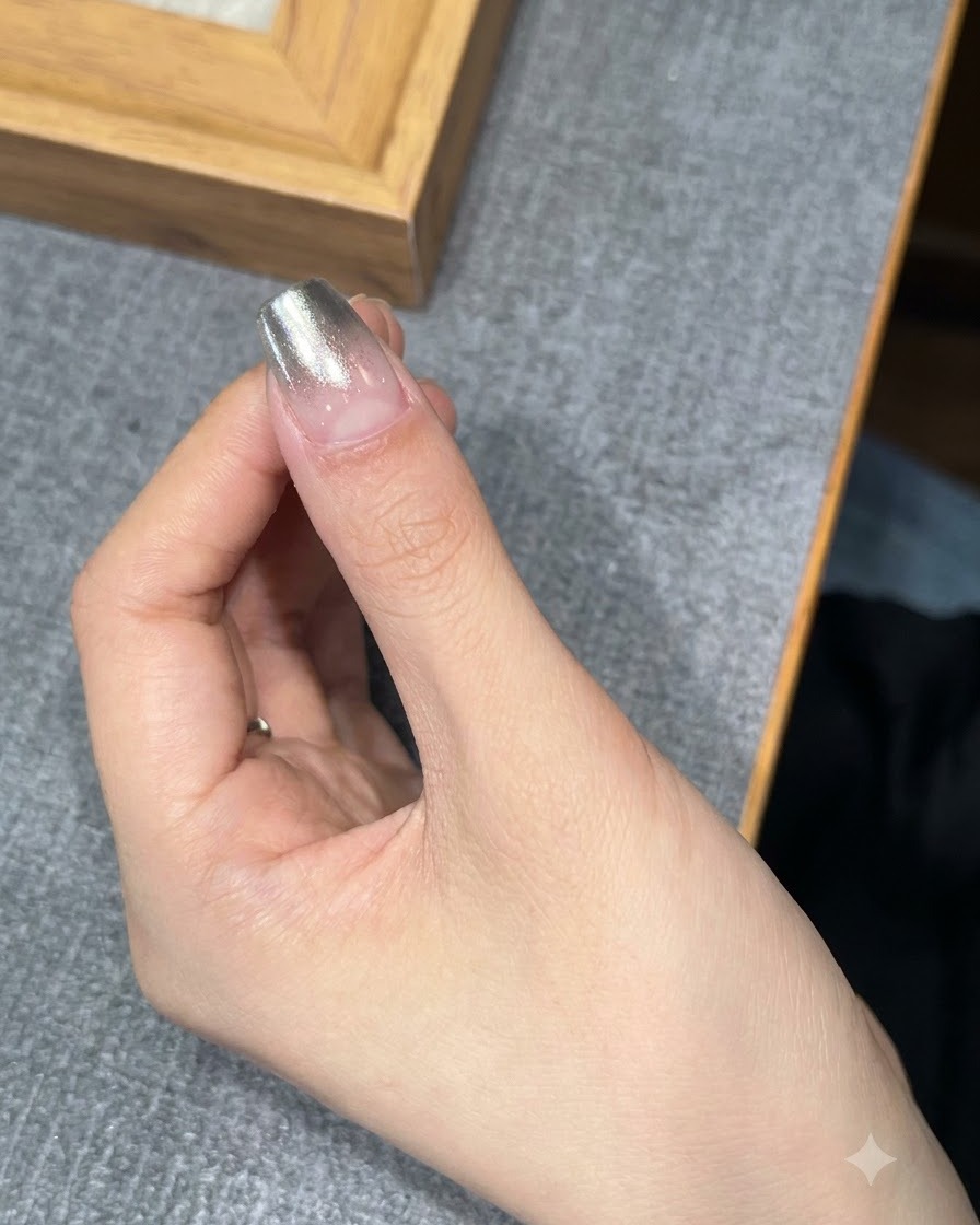 A fingernail placed under a UV or LED lamp for curing.