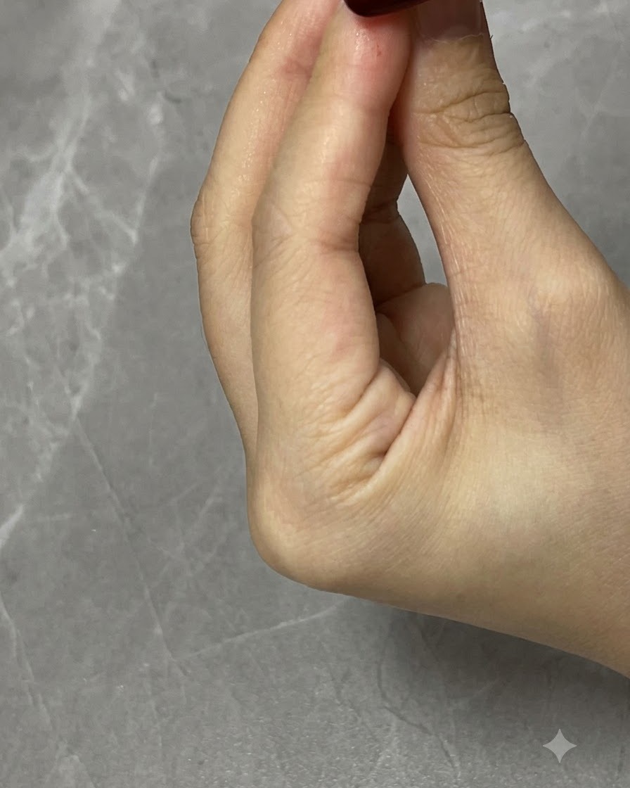 A nail curing under a UV/LED lamp after shaping the cat eye particles.