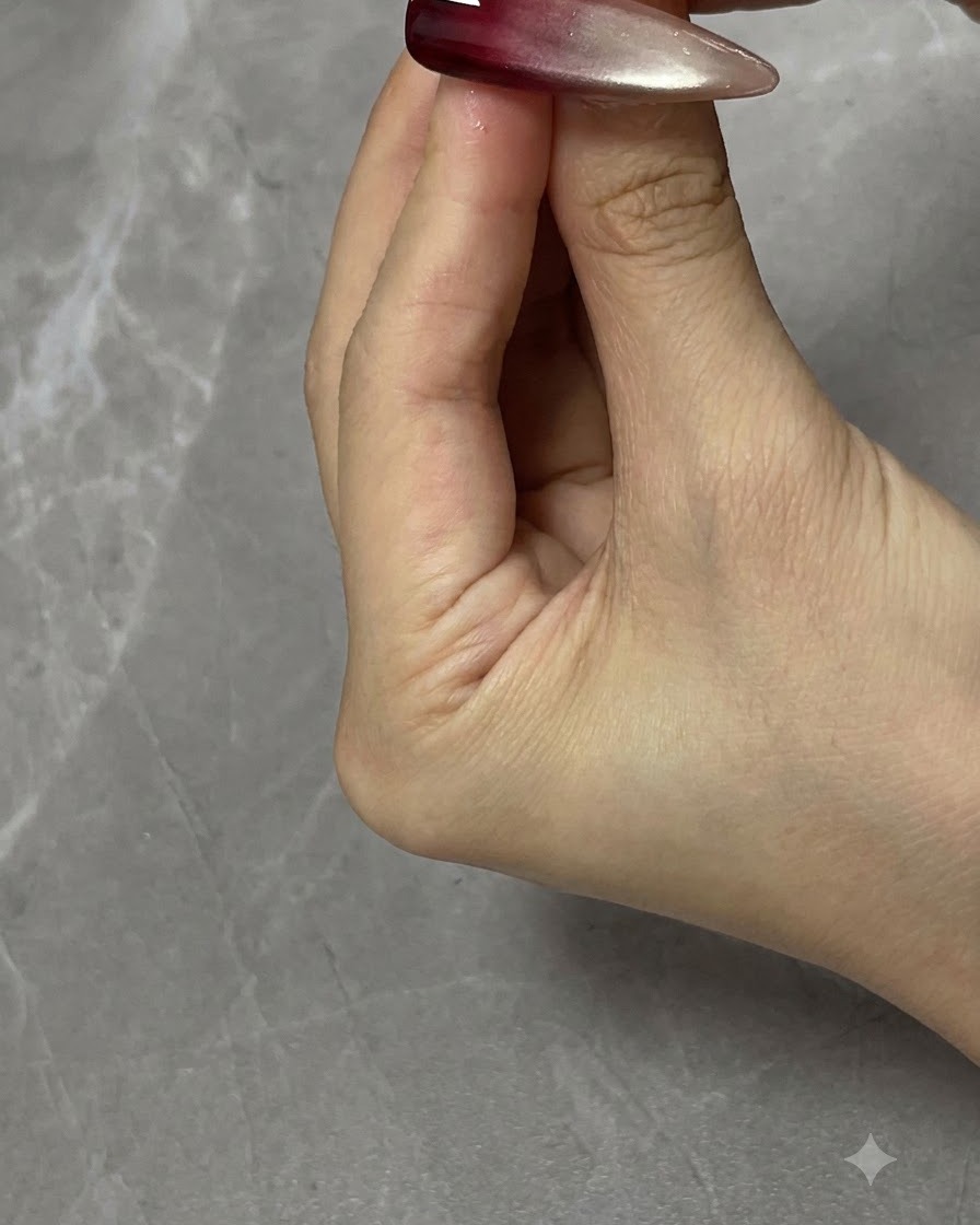 A finger gently patting the wet gel surface to diffuse hard lines and create an ombre gradient transition.