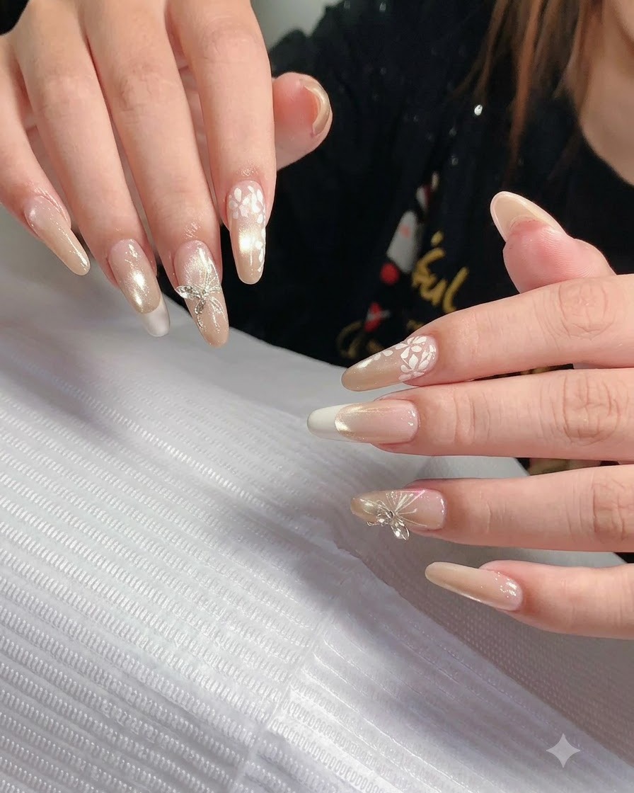 A close-up view of hands rotated slightly to display the smooth curve and even sidewalls of long sculpted nails.