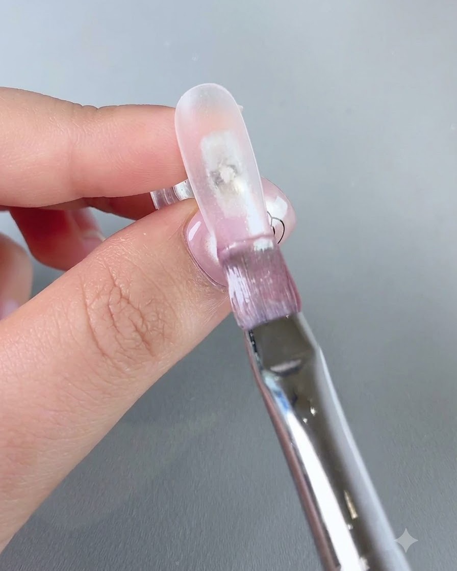 A brush applying clear water gel No. 3 onto the front edge of a nail.