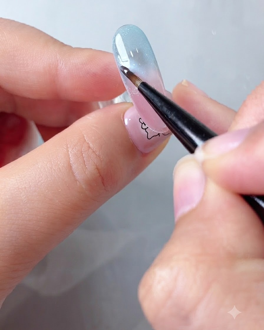 A fine brush diffusing the edges of white cloud gel on a gradient nail background using blooming gel.