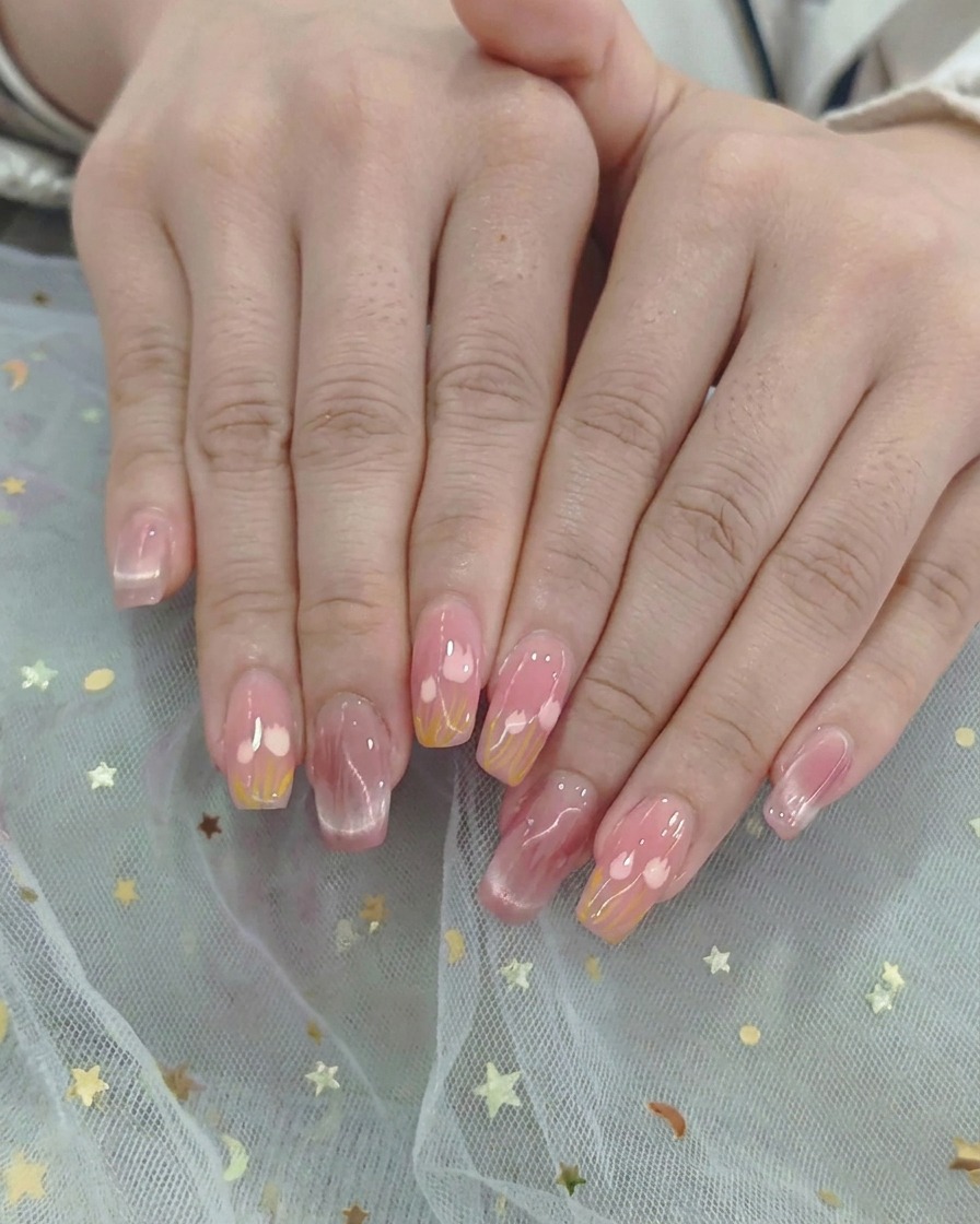 Two hands placed inside a professional UV/LED nail lamp curing gel polish under bright purple light.