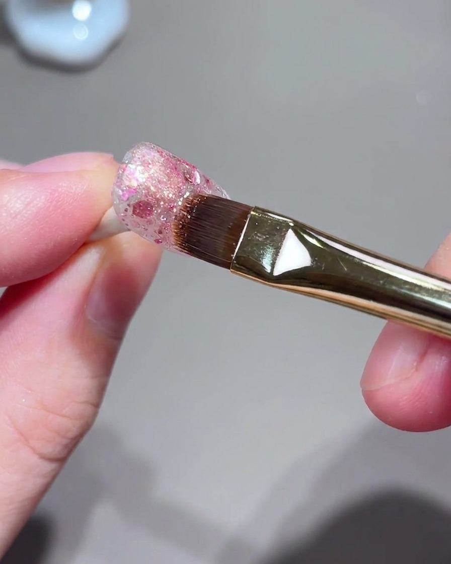 A brush and nail setup during the cat-eye magnetic light gathering process.