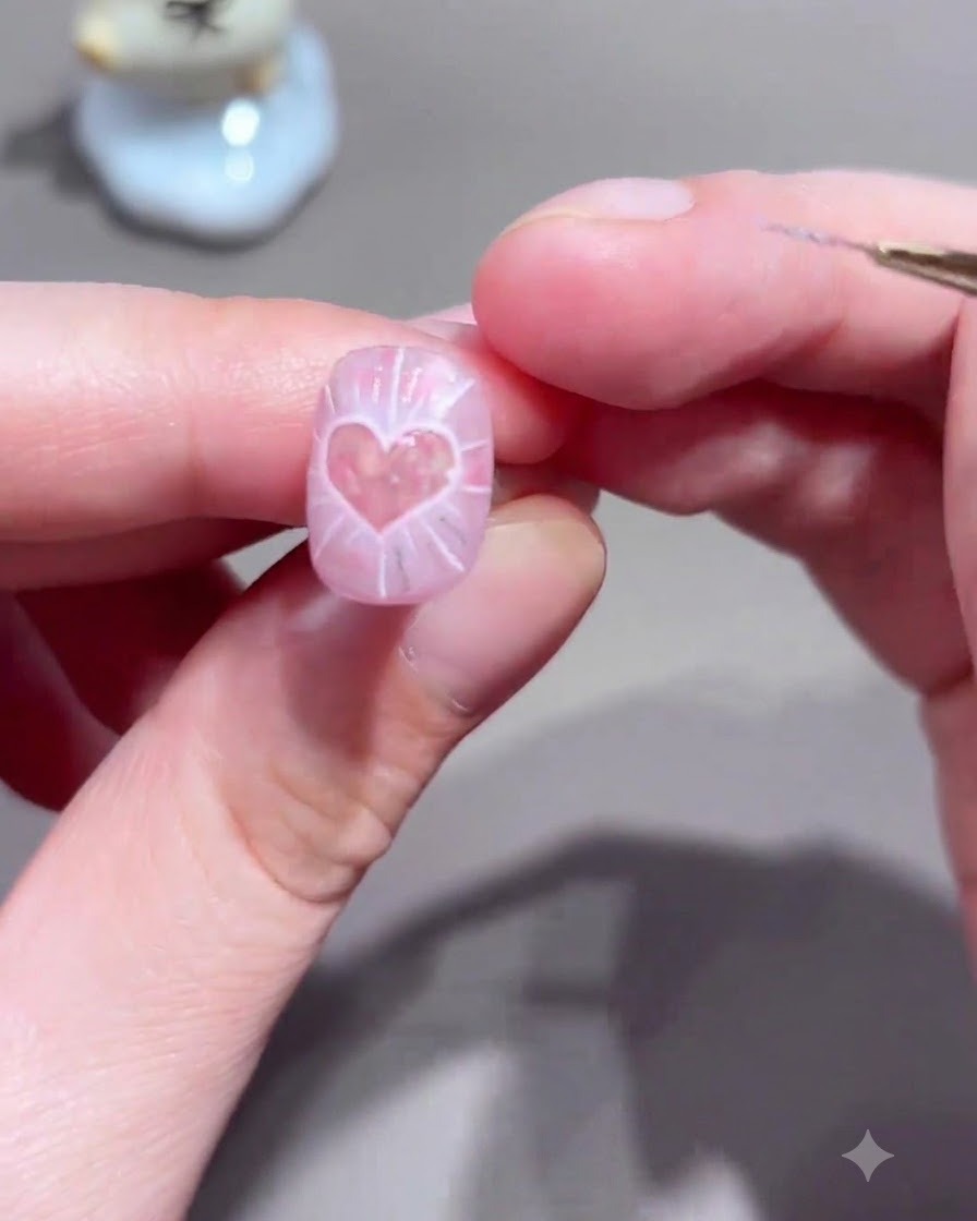 A nail brush applying a clear sealing top coat over the completed light wave nail art design.