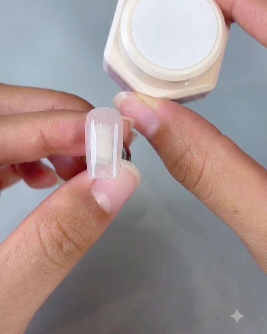 A sponge tool dabbing Gentle No. 1 gel onto the tip of the nail to create an ombre gradient effect.