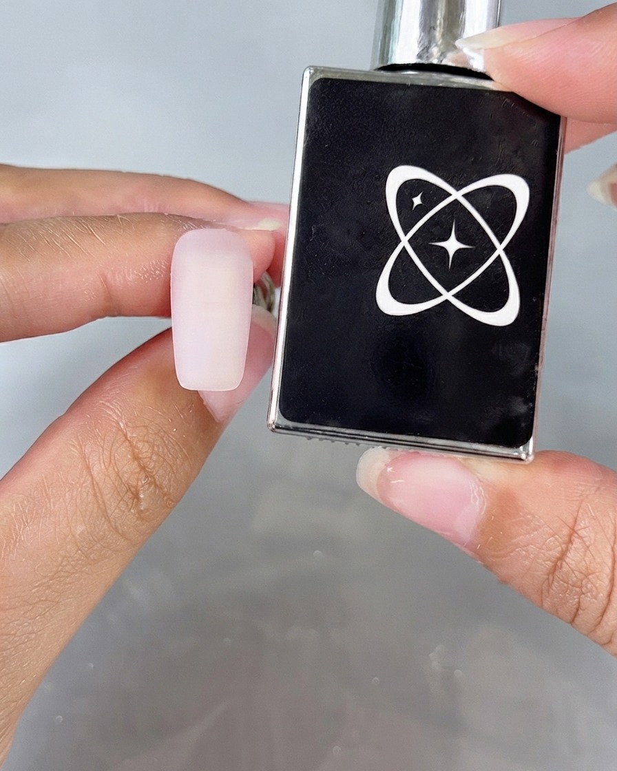 A matte-looking nail surface next to an anti-powder top coat bottle.