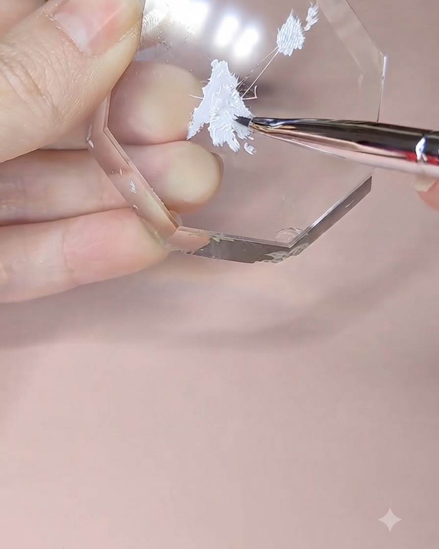 A detail brush picking up white painting gel from an octagonal acrylic palette.
