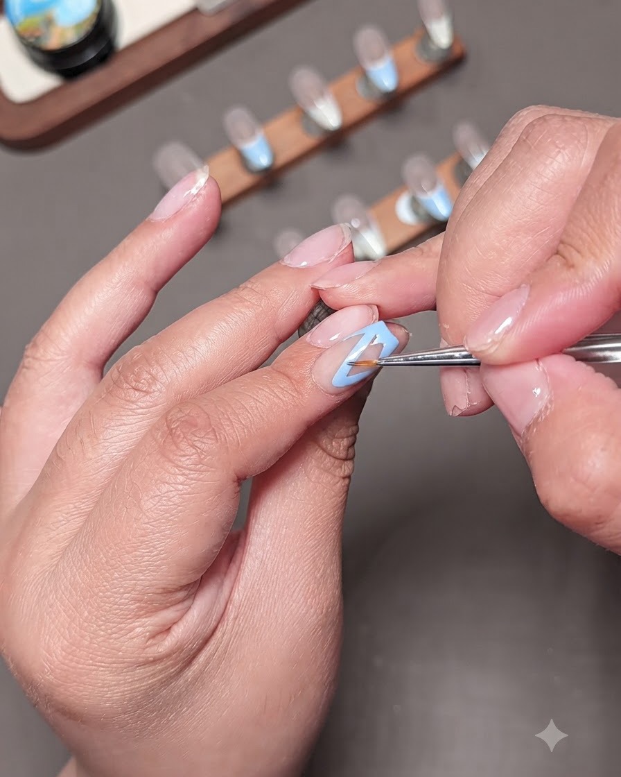 A close-up of a clear-handled dotting tool hovering over a nail to apply yellow details.